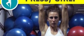 Workout for shoulders and triceps: dumbbell shoulder press on an exercise ball